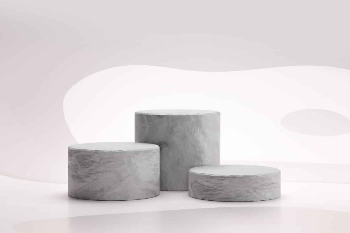 Stone showcase or rock podium stand on abstract white background with marble concept. Pedestal of product display for design. 3D rendering.